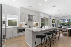 Sleek modern kitchen with island seating and open layout.