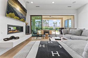 Stylish living room with fireplace and patio access.