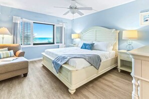 Unwind in a comfortable bedroom featuring a king-size bed, soft linens, and wide window with ocean view.