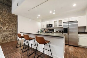 This sleek and stylish kitchen offers top-notch appliances and ample counter space for cooking.