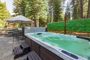 Hot tub: Private 10–12 person hot tub in backyard with patio access