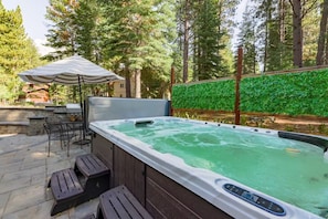 Hot tub: Private 10–12 person hot tub in backyard with patio access