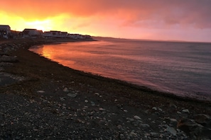 View of the sunset and beachfront directly across the street from the home
