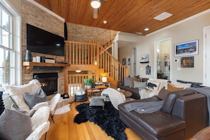 Curl up in this cozy living room with a crackling fireplace, the perfect spot to unwind after a long day.