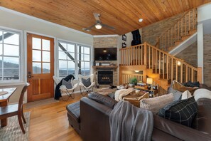  Curl up in this cozy living room with a crackling fireplace, the perfect spot to unwind after a long day.