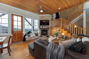 Curl up in this cozy living room with a crackling fireplace, the perfect spot to unwind after a long day.