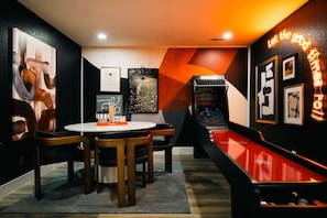 Lower level game room featuring ski ball and game table