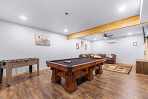 Game/ TV room downstairs with a pool table and a foosball table