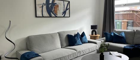 Step into style and comfort in this modern lounge—featuring plush seating, elegant decor, and plenty of natural light for a relaxing stay.