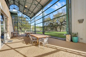 Spacious screened in porch with dining is the perfect space for company to gather