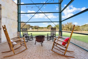 Enjoy a starry Texas sky around the firepit from the comforts of the screened in porch