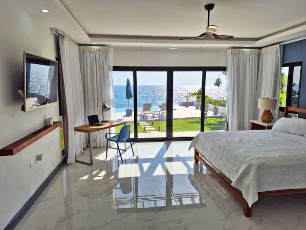 Serendipity by the Sea primary bedroom with direct access to pool, and sea.