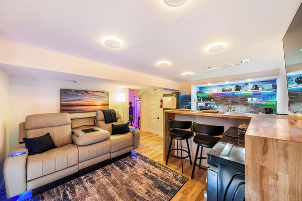 Living Room with TV, Washer, Dryer, and Leather Reclining Sofa