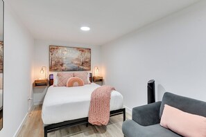 Queen Bedroom with Mirror, Floor Fan, Dresser, TV and Sofa Seat