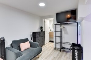 Queen Bedroom with Mirror, Floor Fan, Dresser, TV and Sofa Seat