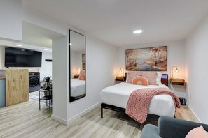 Queen Bedroom with Mirror, Floor Fan, Dresser, TV and Sofa Seat