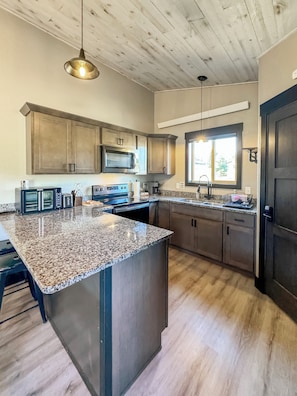 Kitchen--fully stocked to make your stay comfortable if you choose to stay in!