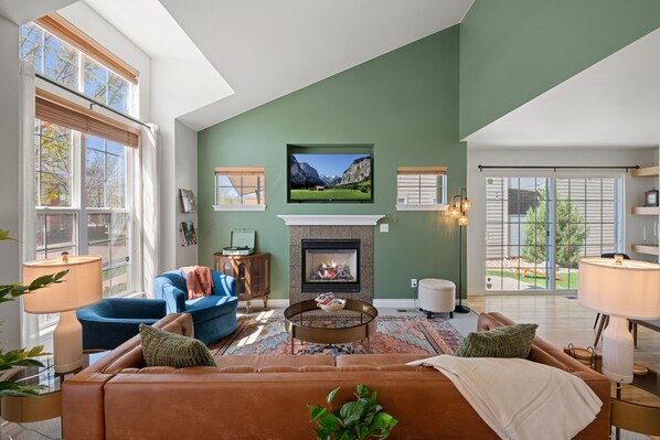Designed with a luxe vintage flair, the living room offers the perfect blend of comfort and style. Sink into the spacious sofa or one of the plush chairs—there’s ample seating for the whole family to gather and unwind. Catch the game or your favorite show on the large smart TV, complete with ROKU streaming options so you can watch your favorite movies or shows. For quieter mome...