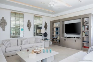 Outdoor lounge area opening onto the terrace and the pool. Indoor air-conditioned living room with HD-TV, Dish network, DVD player, Apple TV.