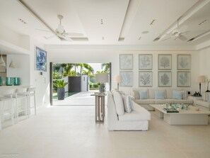Outdoor lounge area opening onto the terrace and the pool. Indoor air-conditioned living room with HD-TV, Dish network, DVD player, Apple TV.