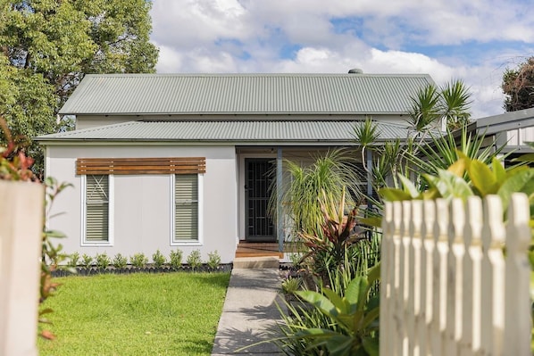 Surrounded by lush lawn and greenery, this single-level home offers privacy, essentials, and easy access to some of the region’s pristine beaches, shopping, and nature.
