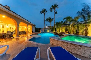 Lounging poolside with cozy lighting and comfortable chairs