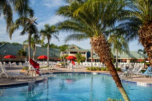 Experience luxury at this sprawling resort pool, complete with comfortable seating and a scenic backdrop for your vacation paradise.