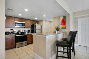Cooking is a breeze in this fully equipped kitchen, complete with stainless steel appliances and a spacious granite countertop for dining.