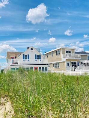 On a dune with loads of beach grass to separate you from the crowds. Enjoy the privacy!