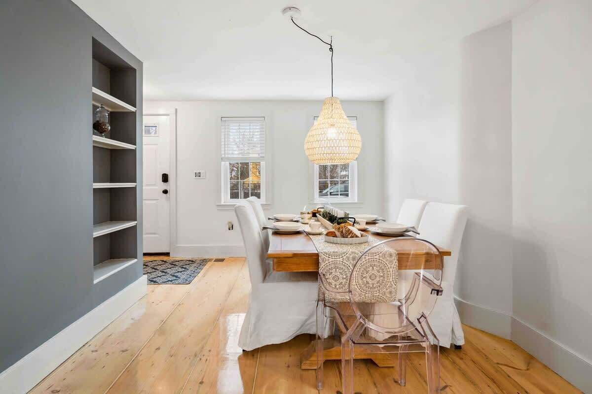 Modern dining room showcasing dining table and original 1750 Pine flooring newly refinished.