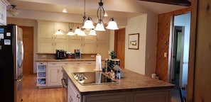 Bright and functional kitchen with large island, perfect for prepping meals or gathering with loved ones.