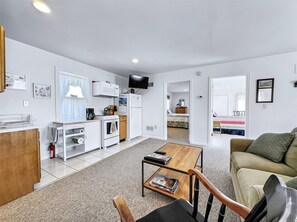 Cozy open-concept living area with plush seating and a TV, ideal for relaxing after exploring Columbia.
