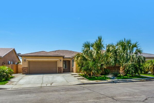 Front Exterior Spacious 2-car garage with additional driveway parking for 2–3 vehicles — perfect for group stays!