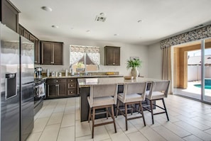 Spacious kitchen island with barstools