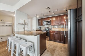 The spacious, fully equipped kitchen beckons you to create a delicious meal or entertain with ease.