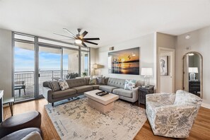 Expansive floor-to-ceiling windows and a doorway offer stunning views both inside and out.