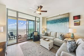 With soaring 10-foot ceilings and floor-to-ceiling windows, the living area is bathed in natural light and offers seamless views of the Gulf just beyond the balcony.