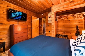 Unwind in the peaceful master bedroom with a full-size bed and a 43" smart TV for late-night movies or morning news.