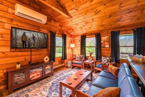 Relax in the inviting living room with a 55" smart TV, plush seating, and an electric fireplace for cozy evenings in.