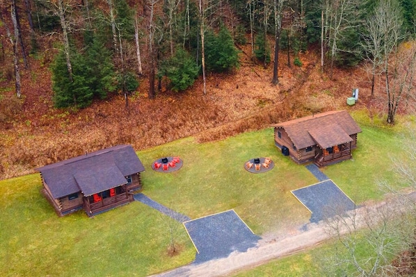 Side-by-side serenity in the heart of the forest—DentonGo Cabins #3 & #4 offer the perfect group retreat with private fire pits, covered porches, and trails just steps from your door. Rent bot