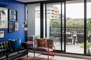 Soak up the sunshine in this bright and colorful living area that opens directly onto a private balcony—perfect for relaxing or enjoying a drink outdoors