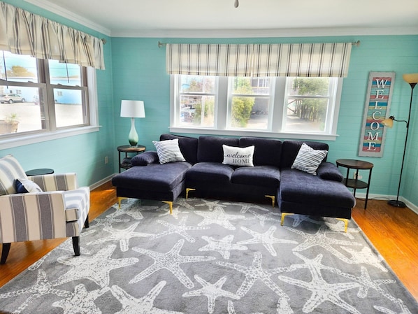 The open-concept Living Area on the Main Level features a flat-screen TV, making it a great space to unwind after a day of sun and surf!