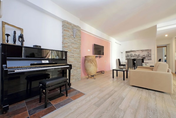 Integrated living and kitchen spaces in an open layout with direct access to a private balcony.
