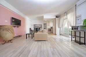 Integrated living and kitchen spaces in an open layout with direct access to a private balcony.