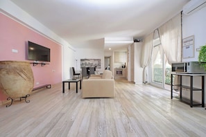 Integrated living and kitchen spaces in an open layout with direct access to a private balcony.