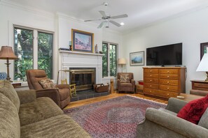 Living room with TV for streaming and wood-burning fireplace