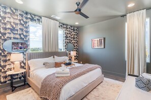 3rd Floor: Stylish primary suite with a king bed, Smart TV, walk-in closet, and private en-suite bath.
