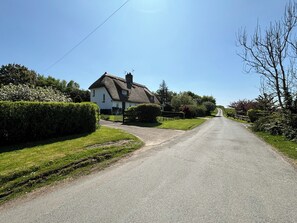 View of the country lane with the cottage on the left