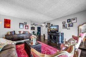 Living Room and Dining Area w SmartTV designed with elegance, eccentricity, and comfort