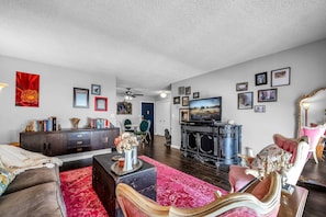 Living Room and Dining Area w SmartTV designed with elegance, eccentricity, and comfort